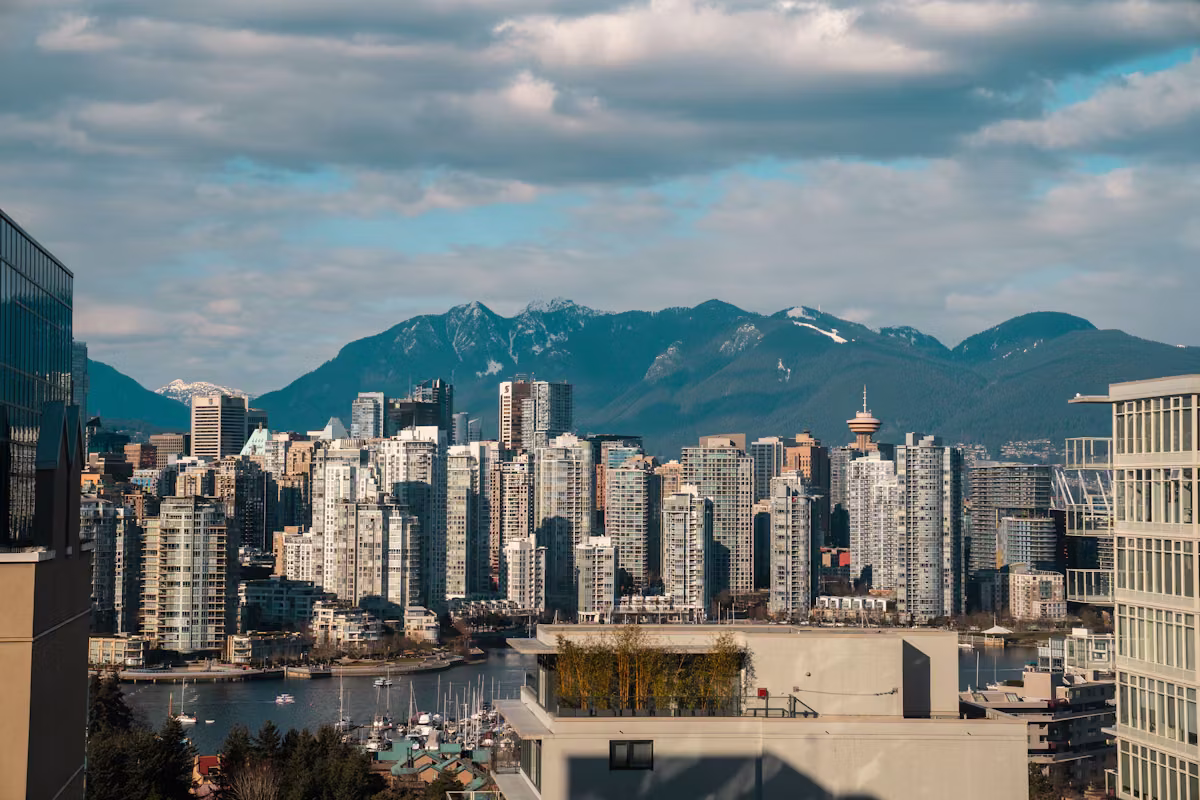 Vancouver high-rise skyline with mountains in the background on a clear day